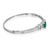 An image of a women's bracelet by Rachel Koen, featuring a sleek white gold metal band adorned with a series of sparkling diamonds and a prominent green emerald gemstone. The bracelet is positioned at a slight angle, showcasing its side profile in white gold. The diamonds are arranged in a line leading to the larger gemstone, creating an elegant focal point. The image is taken at a close distance, highlighting the intricate details and craftsmanship of the piece.