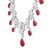 An image of a women's necklace by Rachel Koen featuring an intricate design with diamonds and red ruby gemstones. The necklace is shown from a close side angle, highlighting the alternating pattern of sparkling diamonds and teardrop-shaped rubies. The diamonds are arranged in floral clusters, adding elegance to the piece in white gold. The focus is on the central portion of the necklace, showcasing the detailed craftsmanship and vibrant colors.
