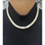 An image of a necklace with opal gemstones from the brand Rachel Koen, designed for unisex adults. The necklace is positioned around the neck, captured from a frontal angle at a close distance. The gemstones are uniformly arranged, creating a visually appealing and elegant appearance against a black ribbed fabric background. Excellent preowned condition.