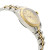 An image of a pre-owned wristwatch showing a side profile view opposite of the crown. The watch features a two-tone metal band with alternating gold and silver links. The gold bezel frames a light-colored dial, and the angle highlights the smooth curves of the watch case. The photo is taken at a close distance, focusing on the watch's elegant design and craftsmanship.