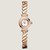 An image of a pre-owned HERMÈS  Faubourg Polka 15mm 18K Rose Gold MOP Diamond Lady's Watch W054184WW00 taken from a straight-on angle, displaying the watch face and intricate bracelet design. The watch features a round face with a mother-of-pearl dial surrounded by a diamond-encrusted bezel. The bracelet is composed of geometrically shaped links, creating a sophisticated and elegant look. The image is captured from a close distance, showcasing the luxurious details and craftsmanship of the timepiece.