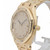 An image of a pre-owned Audemars Piguet women's wristwatch, viewed from a slightly angled side perspective. The watch features a gold bracelet and a diamond-encrusted bezel. The face is adorned with numerous small diamonds, with black hands and a date indicator visible on the right side. The crown is positioned prominently on the right, showcasing intricate detailing. The watch is displayed on a stand against a neutral background.