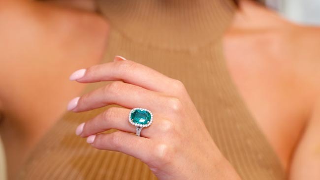 An Image Of female hand displaying two diamond bands in white gold