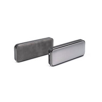 A pair of rectangular Bluetooth speakers in black and silver, featuring a textured finish and a logo.