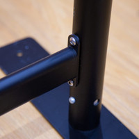 A close-up of a black metal frame, featuring a connector and base plate for stability.