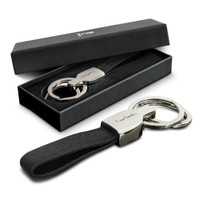 A sleek black key ring with a silver key holder, presented in a black gift box.