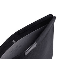 A black laptop sleeve with a soft interior lining and a logo. The opening reveals a sleek design.
