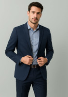 A navy blue men's blazer, tailored fit, worn over a light blue shirt, featuring a logo on the lapel.