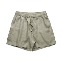 Linen dress shorts in a light green shade with an elastic waistband and drawstring. Features branding.