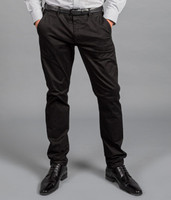 A pair of black chinos worn with a grey shirt and black shoes, featuring a subtle logo on the waistband.