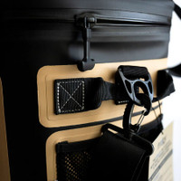 Durable tan and black travel bag with sturdy zipper and strap design.