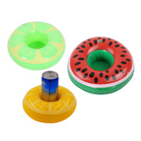 Three inflatable cup holders in bright colours: green, red, and yellow, featuring fruit designs. A can is placed in one holder.
