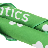 A green triangle pet bandana featuring white spots and a logo.