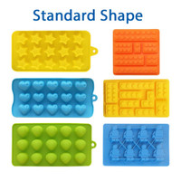 Custom shaped moulded ice cube trays in vibrant colours: yellow stars, blue hearts, green shells, orange and blue brick designs.