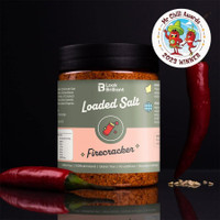 Jar of Smokey Joe's Loaded Salt "Firecracker" with a black lid, accompanied by a red chili pepper, featuring a 2023 winner badge from Mr Chilli Awards.
