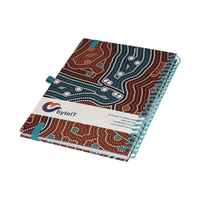 A A5 side-bound notebook with a distinctive Aboriginal art design in brown, red, and blue, featuring a logo on the cover.