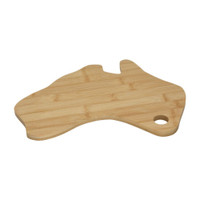 A bamboo cheese board shaped like Australia featuring a hole for hanging. It has a natural wood finish.