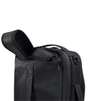 Black carry-on luggage with an open zip pocket.