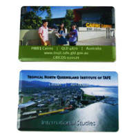 A flat USB drive featuring images of Cairns and the Tropical North Queensland Institute of TAFE, with various colours.