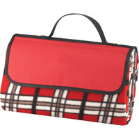 A folded picnic blanket in red with a black and white tartan pattern, featuring a carrying handle.