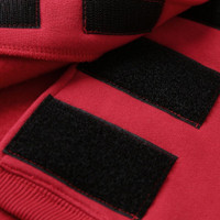 Detail of velcro straps part of a red coloured dog hoodie