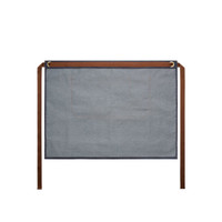 A denim half apron in blue with brown ties, featuring two pockets and a branded logo.