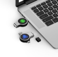 Double ended swivel flash drives in black and silver, featuring a logo, placed beside a laptop keyboard.