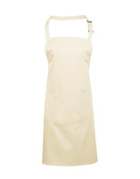 A beige bib apron with a pocket and adjustable straps, featuring a logo.