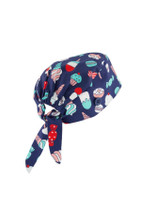 A unisex printed scrub cap in navy featuring colourful patterns of ice cream and desserts, with a tied back design.