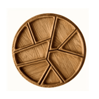 A round wooden platter divided into sections, showcasing a natural wood finish and organic shapes.