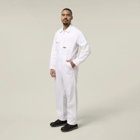 Side view of a male model wearing a white work jumpsuit and black work boots against a neutral background.