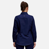 Back view of a woman wearing navy blue long-sleeve utility shirt and blue jeans.