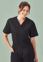A unisex pulse v-neck scrub top in black, featuring short sleeves and a front pocket.