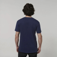 Man wearing navy blue t-shirt facing backward against gray background.