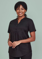 A black women's tunic scrub top with a buttoned front and a relaxed fit, featuring a logo.