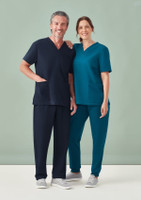 A navy blue and teal women's V-neck scrub top paired with matching pants, presented on a male and female model.