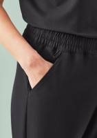 A close-up of women's black jogger scrub pants featuring an elastic waistband and side pockets.