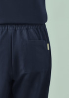 Navy women's jogger scrub pant featuring a back pocket and elastic waistband. Includes a branding label.