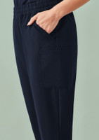 A pair of women's jogger scrub pants in navy blue, featuring a side pocket and an elastic waistband.