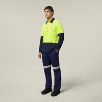 Man wearing high-visibility workwear with safety reflective pants and bright yellow top.