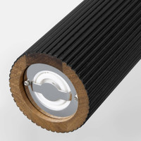 Black cylindrical salt and pepper grinders with a ridged texture and a wooden base, featuring a metal logo on the bottom.