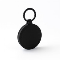 A black round keychain with a textured surface and a keyring attachment.