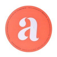A round orange mouse mat featuring a large white letter 'a' and a small logo.