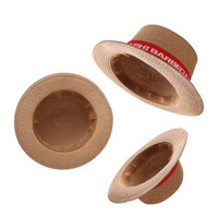A straw hat with a wide brim and a ribbon band. The hat is natural tan colour with a red ribbon accent.