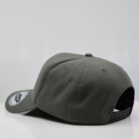 A green six-panel snapback cap featuring a logo on the side and a flat brim.