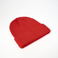 A red beanie with a ribbed texture, featuring a folded cuff. It has a logo on the front.