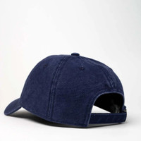 Blue denim baseball cap with adjustable strap, rear view.