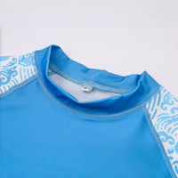 A blue rashie featuring short sleeves, with decorative patterns along the shoulders and a crew neck design.