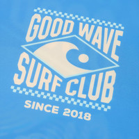 A blue rashie featuring a logo for the "Good Wave Surf Club" with stylised elements and a wave design.