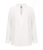 Asha Long Sleeve Top in white, featuring a half-open neck and long sleeves. It has a subtle branding detail.